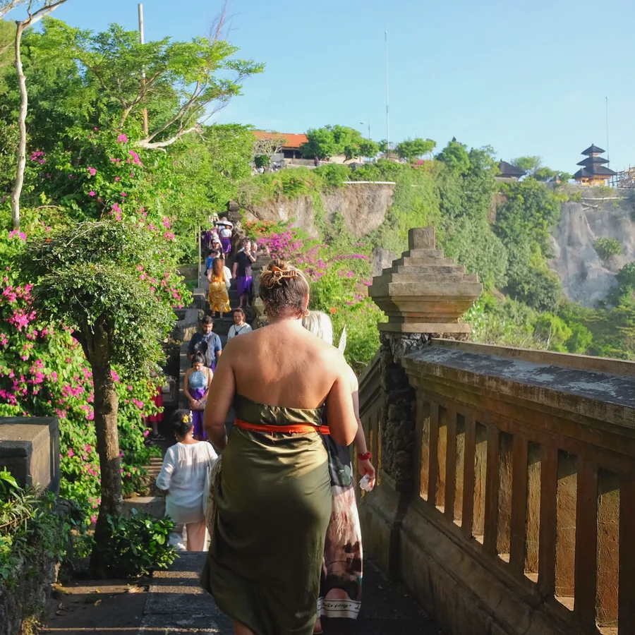 Cliff steps up to the temple, framed by bougainvillea