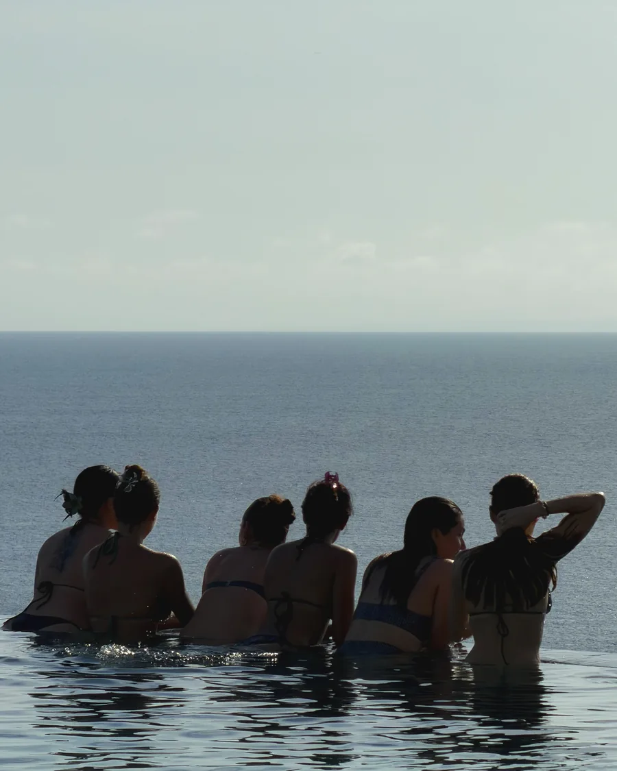 The group together in the pool, watching the horizon